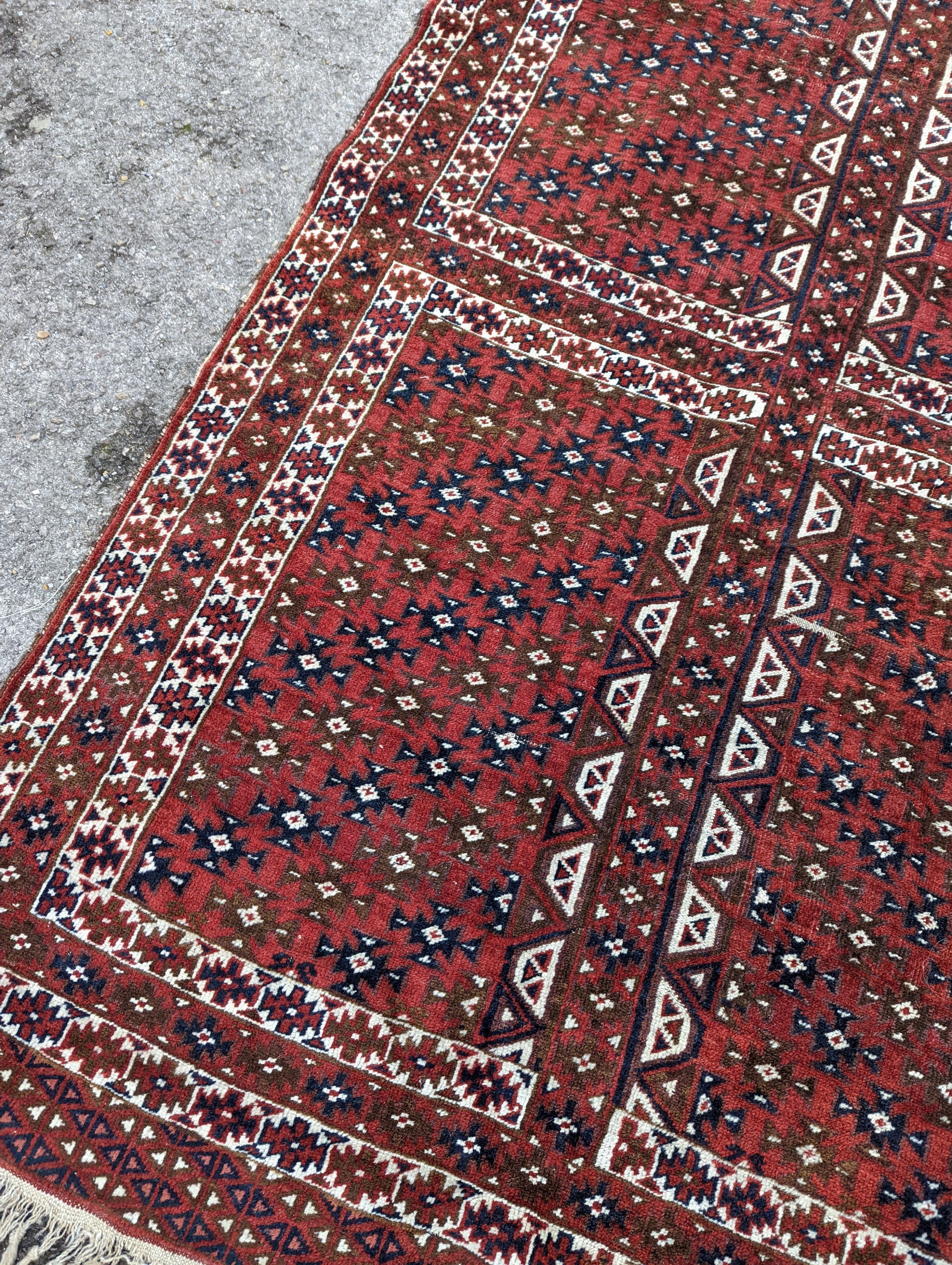 A Belouch red ground rug, 200 x 130cm